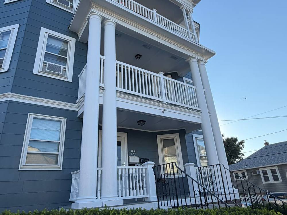 Exterior painting of a triple-decker porch in Lynn, MA