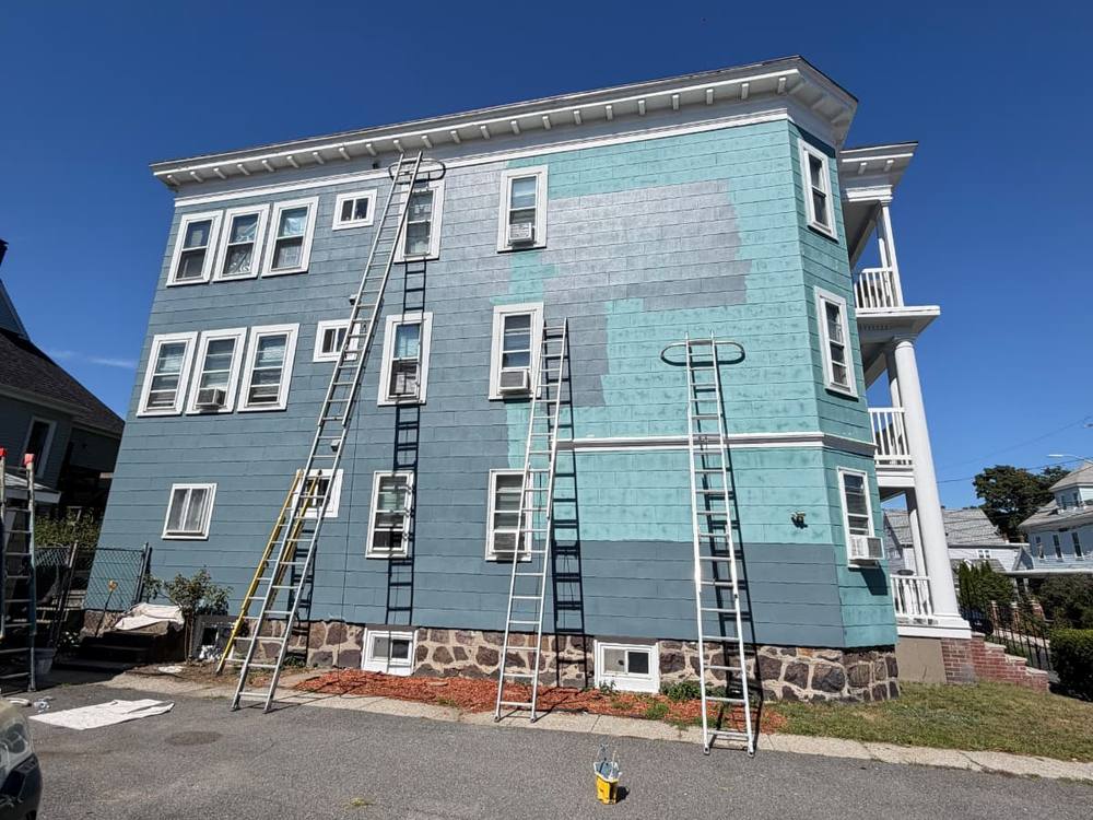 Exterior siding painting in progress in Lynn, MA